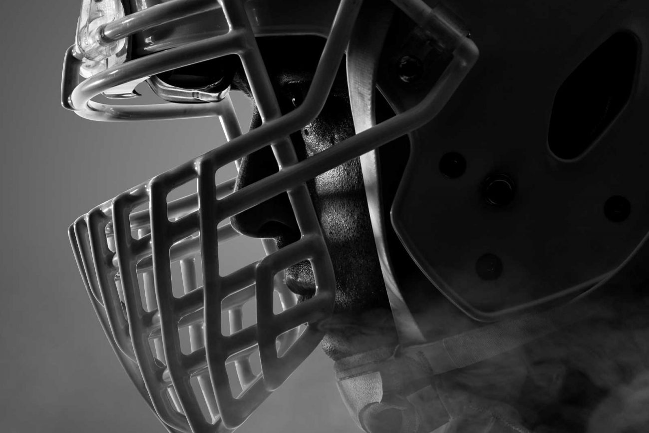 Close-up of an athlete wearing a football helmet, symbolizing resilience and precision in web development in Saudi Arabia.