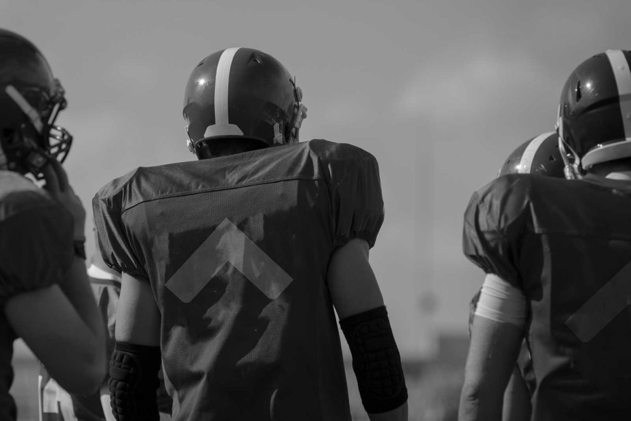 A team of football players in uniform, representing teamwork and collaboration, symbolizing the process of web development in Saudi Arabia.