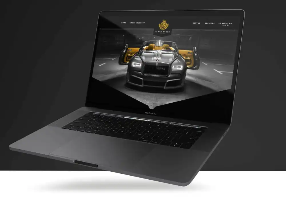 Black Badge website displayed on a sleek MacBook showcasing a luxury car with open doors