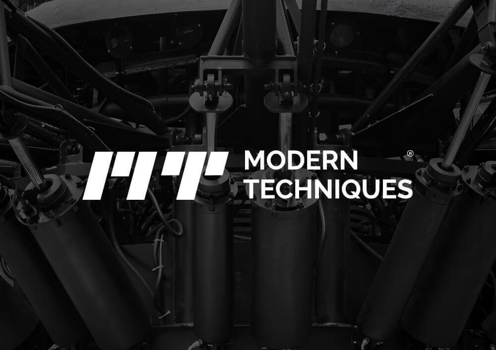 "Modern Techniques logo with hydraulic device machinery, created by a top branding company in Saudi Arabia, featured on a digital agency website."